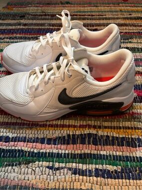 Nike White Sneakers with Black Swoosh and Orange Accents